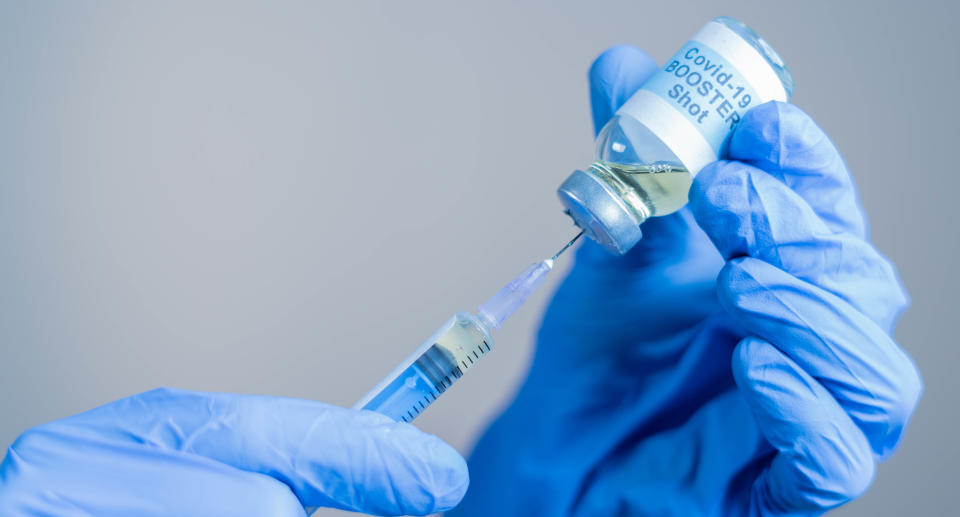 Focus on syringe, close up of doctor or nurse hands taking covid vaccination booster shot or 3rd dose from syringe. Source: Getty Images 