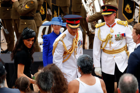 Britain's Prince Harry and Meghan, Duchess of Sussex, accompanied by Governor of New South Wales David Hurley and his wife Linda, stop to talk to a group of indigenous Australians as they leave the enhanced ANZAC memorial in Hyde Park, Sydney, Australia October 20, 2018. REUTERS/Rick Stevens