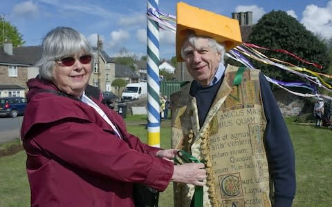 Locals with the maypole in the background - Credit: Stephen Cassidy/SWNS