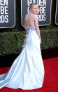 wears a strapless silver Armani Privé gown with a trail of bow details down the back to the Golden Globe Awards.