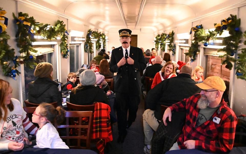 A conductor addresses passengers on The Polar Express Train Ride as it make its way to the North Pole from the National Railroad Museum in Ashwaubenon. All 12,000-plus tickets for this year's four-weekend event sold out in 24 hours.