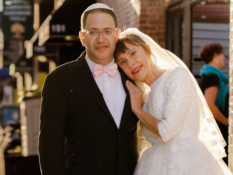 Groom Yossi Rosenberg, left, poses with bride Ivy Branin, right, at their June 2022 wedding.