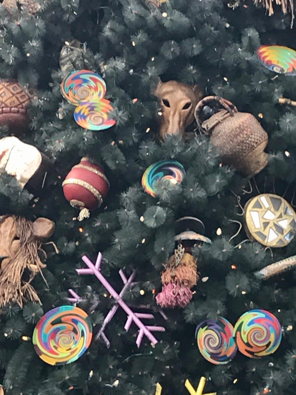 Animals peek from between the branches of the tree at the entrance to Animal Kingdom at Walt Disney World.