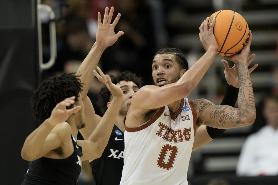 Texas forward Timmy Allen looks to pass against Xavier in the first half of a Sweet 16 college basketball game in the Midwest Regional of the NCAA Tournament Friday, March 24, 2023, in Kansas City, Mo. (AP Photo/Charlie Riedel)