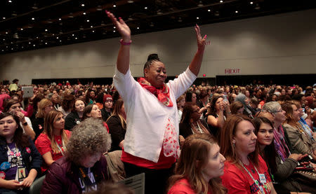 Attendee Andella White raises her hands during the three-day Women's Convention at Cobo Center in Detroit, Michigan, U.S., October 28, 2017. REUTERS/Rebecca Cook