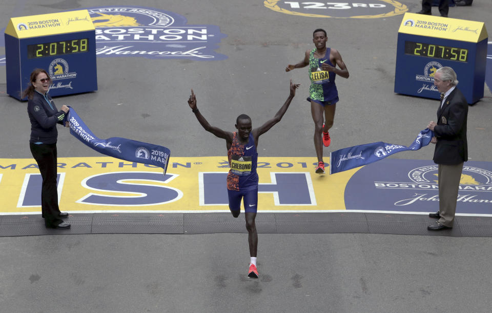 Lawrence Cherono, of Kenya, breaks the tape to win the 123rd Boston Marathon in front of Lelisa Desisa, of Ethiopia, right, on Monday, April 15, 2019, in Boston. (AP Photo/Charles Krupa)