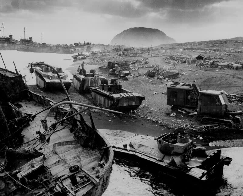 Wrecked U.S. Marine vehicles litter an Iwo Jima beach