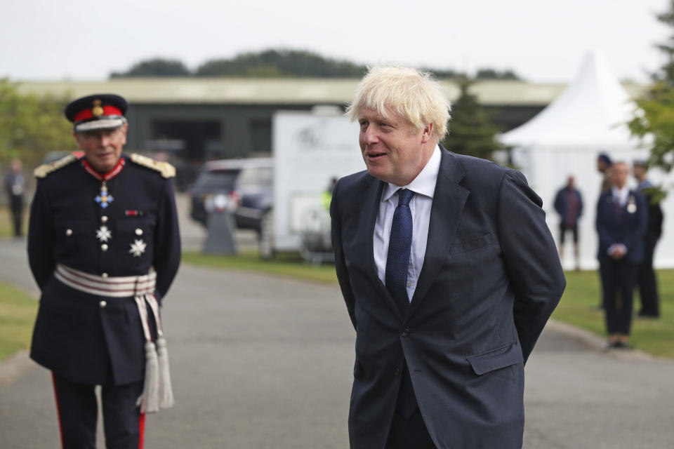 Britain's Prime Minister Boris Johnson arrives to attend the national service of remembrance marking the 75th anniversary of VJ Day at the National Memorial Arboretum in Alrewas, England, Saturday Aug. 15, 2020. Boris Johnson paid tribute to surviving veterans of the multinational campaign against Japan in World War II, which ended 75 years ago, noting the veterans courage during the six-year campaign that cost the lives of some 50,000 troops. (Peter Byrne/PA via AP)