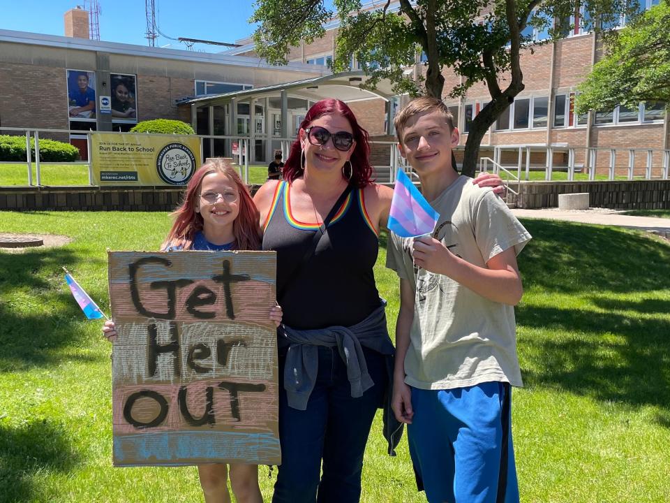 From left, Kaleigha, Jill and Devon Weber participate in a rally calling on MPS to dismiss a counselor and better support trans students.