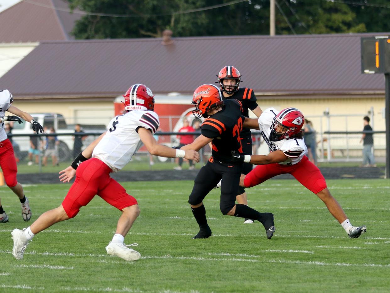 Coshocotn's Antwone Johns brings down Ridgewood's Aidan Sparger on Friday night in West Lafayette.