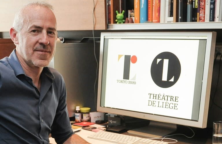 Belgian designer Olivier Debie displays the Tokyo 2020 Olympic emblem (L) and the logo of the Theatre de Liege at his office in Liege, on July 30, 2015