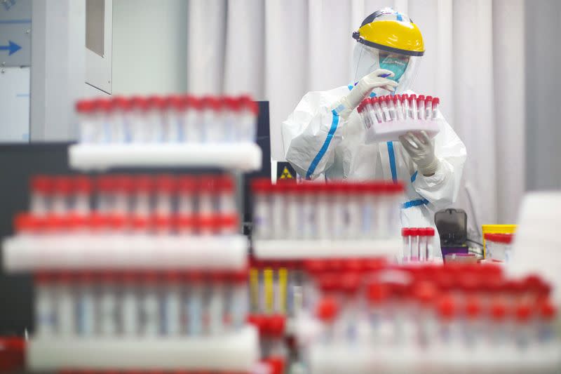 FILE PHOTO: Medical staff works at a nucleic acid testing laboratory following mass COVID-19 testing in Nanjing