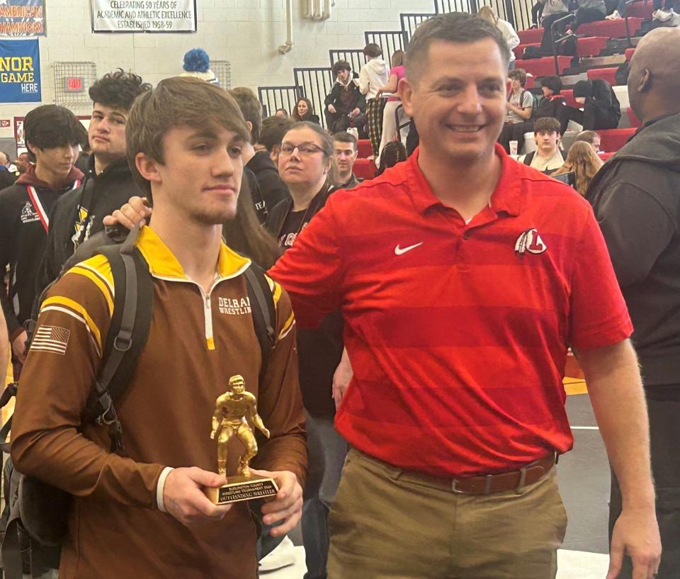 Delran's Drew Roskos (left) is awarded the Outstanding Wrestler award by Lenape head coach Chris Easlick at Sunday's Burlington County Tournament. Roskos won the 157-pound title.
