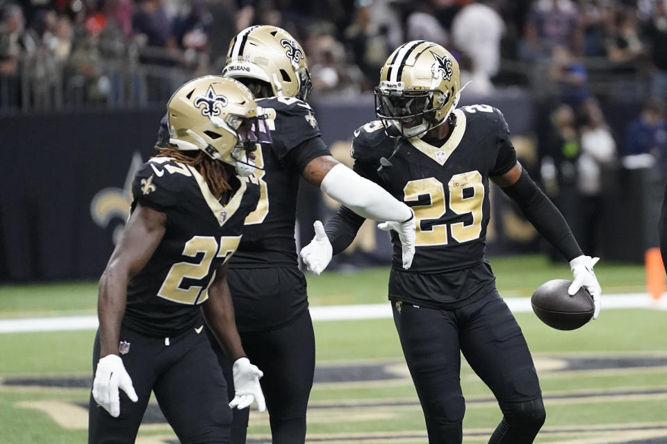 New Orleans Saints cornerback Paulson Adebo (29) celebrates with teammates after intercepting a pass during the second half of an NFL football game against the Chicago Bears in New Orleans, Sunday, Nov. 5, 2023. (AP Photo/Gerald Herbert)