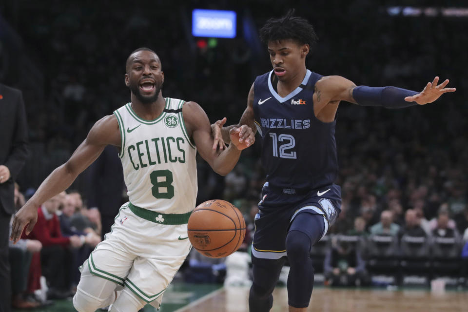 Boston Celtics guard Kemba Walker (8) is fouled by Memphis Grizzlies guard Ja Morant (12) during the second half of an NBA basketball game in Boston, Wednesday, Jan. 22, 2020. (AP Photo/Charles Krupa)