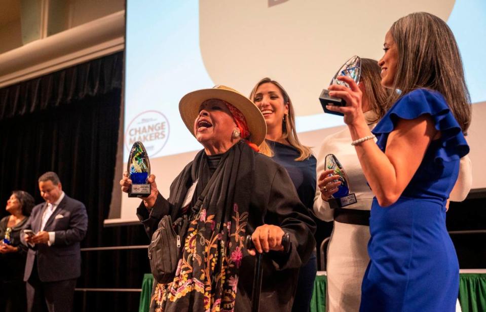 Latino Change Maker Juanita Polendo Ontiveros, center, celebrates on stage with Lisa Cardozo, right, and others as The Sacramento Bee’s Equity Lab and the Nehemiah Emerging Leadership Program hosted the latest 60 leaders at an event held at Sacramento State on Friday night.