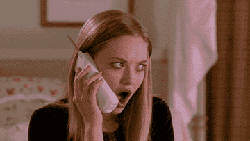 Amanda Seyfried looking shocked while on the phone in Mean Girls