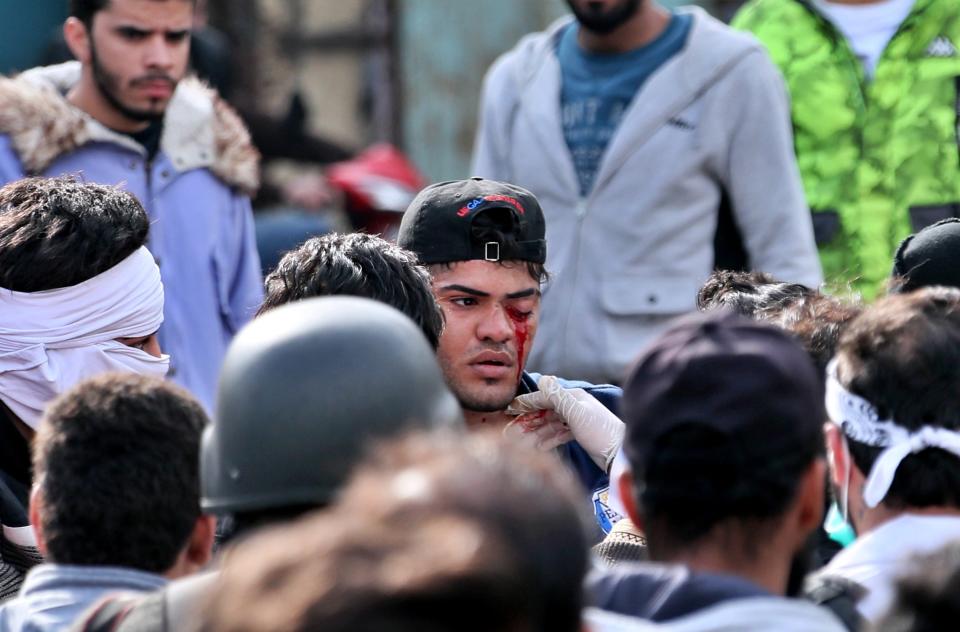 An anti-government protester, center, who was shot with an air rifle by police, is taken to receive first aid during clashes with security forces in Baghdad, Iraq, Wednesday, Jan. 29, 2020. (AP Photo/Hadi Mizban)