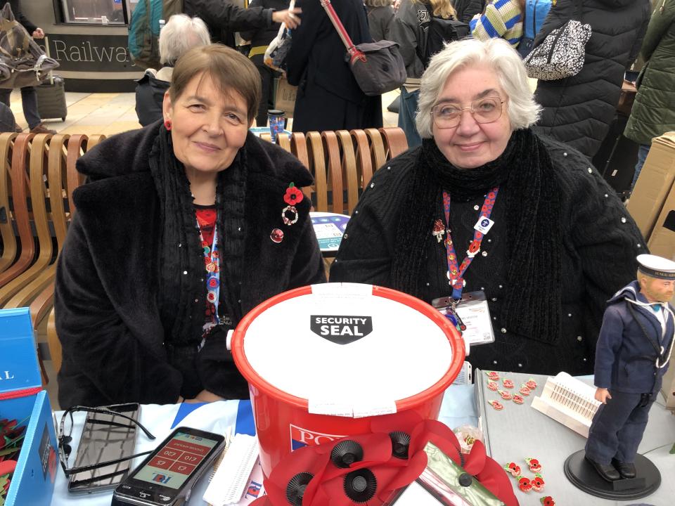 Tracy Cooper, right, with her fellow poppy seller Audrey at Paddington station on Friday. 'We've had no problems at all,' Cooper said. (Yahoo News UK)