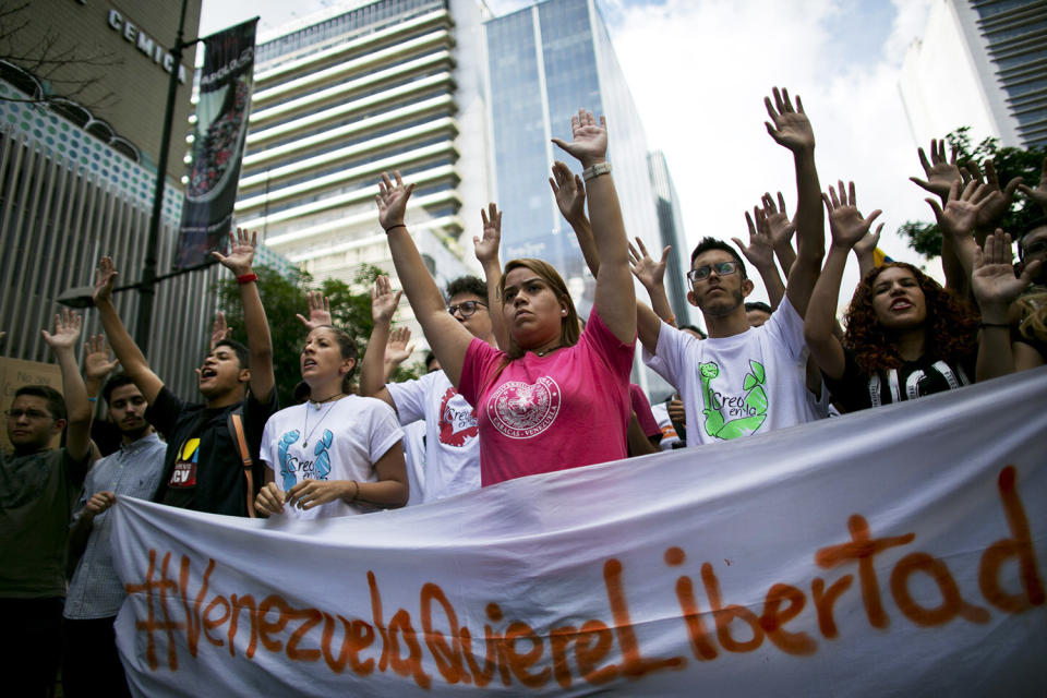 <p>In this Feb. 12, 2017 photo, students hold an anti-government protest to mark the third anniversary since the killing of student protester Bassil da Costa by security forces during weeks of unrest in Caracas, Venezuela. Bassil’s sister, Yenicer da Costa, no longer bothers to protest, even on the anniversary of her brother’s death. “What’s the point of protesting if they just kill you in the streets and three years later, everything is even worse?” she said. (Ariana Cubillos/AP) </p>