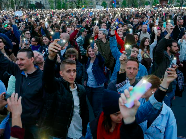 People light with their mobile phones as they protest against the bill that would undermine Central European University, a liberal graduate school of social sciences founded by U.S. financier George Soros in Budapest, Hungary, April 9, 2017. REUTERS/Laszlo Balogh