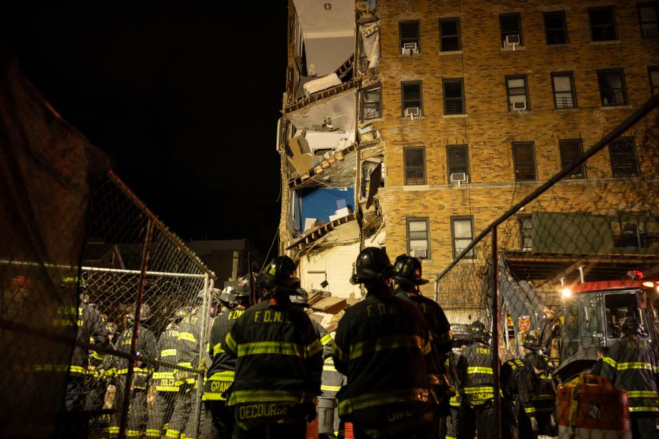 First responders work at the scene of a collapsed building in the Bronx borough of New York, Monday, Dec. 11, 2023.