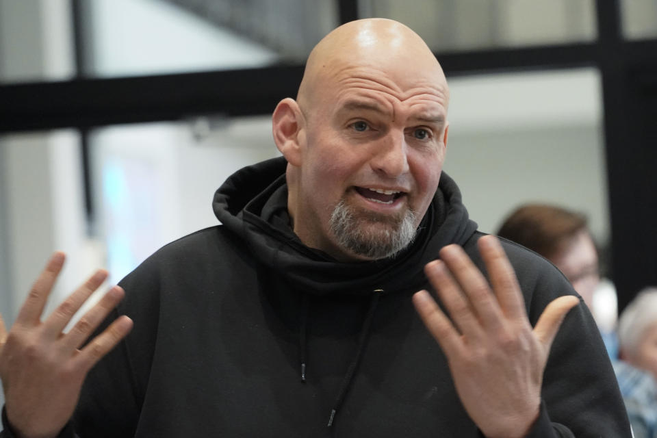 In this photo made on Friday, March 4, 2022, Pennsylvania Lt. Gov. John Fetterman visits with people attending a Democratic Party event for candidates to meet and collect signatures for ballot petitions for the upcoming Pennsylvania primary election, at the Steamfitters Technology Center in Harmony, Pa. Fetterman is running for the party nomination for the U.S. Senate. The irreverent, blunt, 6 feet 8, tattooed Fetterman faces the Pennsylvania's Democratic Party committee backed U.S. Rep. Conor Lamb and Malcolm Kenyatta, a second-term state representative from Philadelphia. (AP Photo/Keith Srakocic)