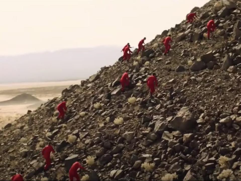 Victory henchmen climbing a hill in "Don't Worry Darling."