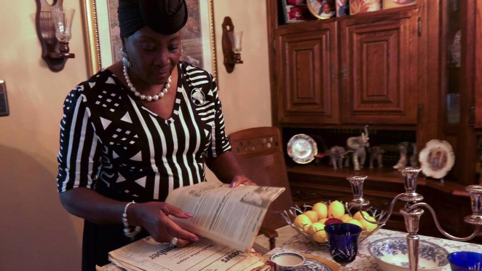 Forestine Reid, sister of Arthur Lee McDuffie, looks over newspaper clippings reporting on her brother’s death in a scene from ‘When Liberty Burns.’