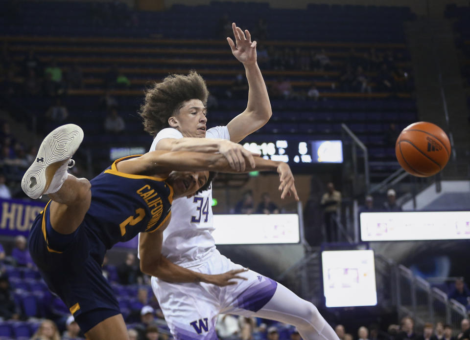 California forward Monty Bowser (2) and Washington center Braxton Meah (34) collide near Washington's basket during the first half of an NCAA college basketball game Saturday, Jan. 14, 2023, in Seattle. (AP Photo/Lindsey Wasson)