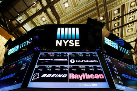 A screen displays trading information for Northrop Grumman, United Technologies, Boeing and Raytheon on the floor of the New York Stock Exchange (NYSE) in New York City, U.S., January 24, 2017. REUTERS/Brendan McDermid