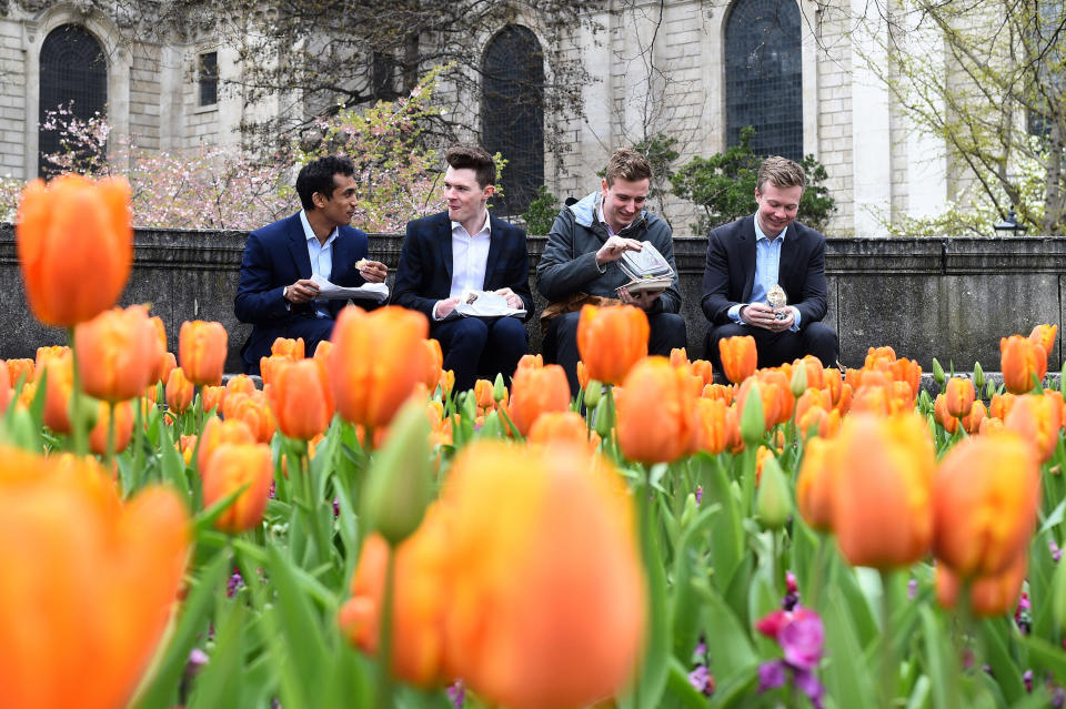 Workers eat their lunch outside St Paul’s Cathedral in London (Picture: PA)