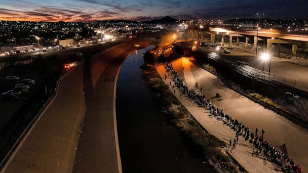 PHOTO: Hundreds of migrants line up on the north side of the Rio Grande as they await to seek asylum in El Paso, Texas, Dec. 11, 2022. (Omar Ornelas/usa Today Network/via Reuters)