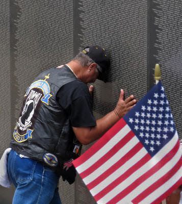 A veteran pays tribute to fallen comrades at Wall South at Veterans Memorial Park in Pensacola in 2017.