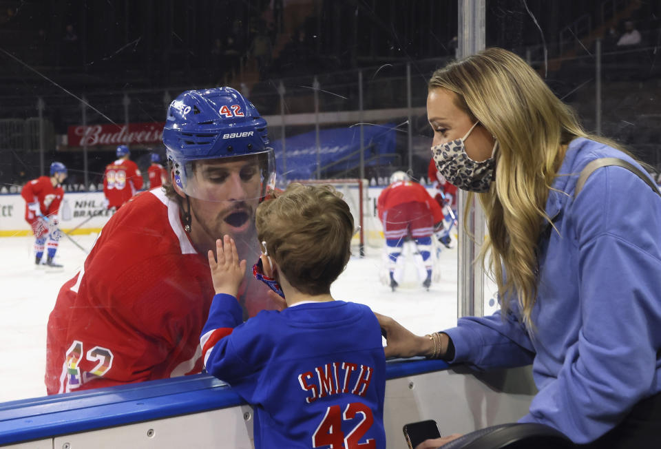 New York Rangers' Brendan Smith (42) says hello to his son Nolan and wife Samantha during warmups prior to an NHL hockey game against the Washington Capitals in New York, Monday, May 3, 2021. (Bruce Bennett/Pool Photo via AP)