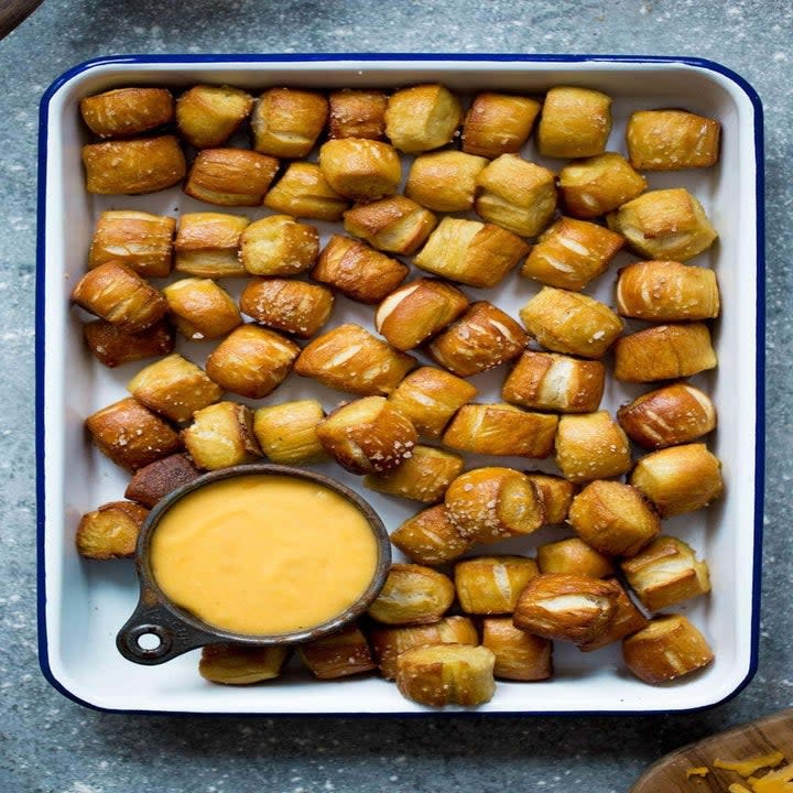 A serving tray of pretzel bites and dipping sauce.