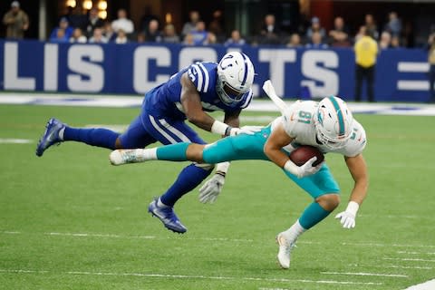 Miami Dolphins tight end Durham Smythe (81) is pushed out of bounds by Indianapolis Colts linebacker Darius Leonard (53) during the first quarter at Lucas Oil Stadium - Credit: Brian Spurlock/USA TODAY