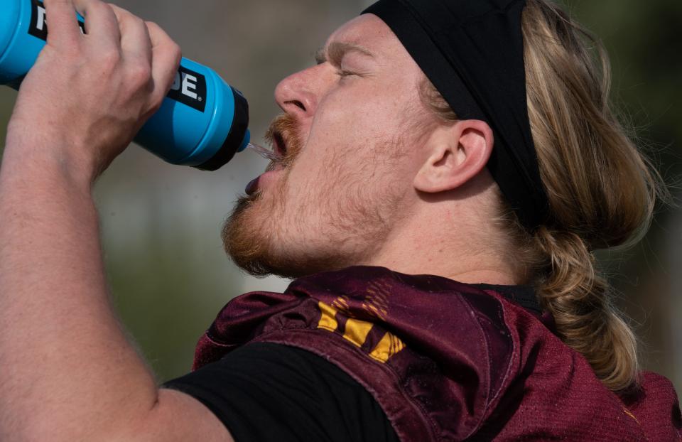 ASU football offensive lineman Emmit Bohle gets a drink during practice on March 26, 2024, at ASU's Kajikawa Practice fields in Tempe.