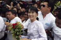 FILE - Myanmar pro-democracy leader Aung San Suu Kyi, center, arrives at the headquarters of her National League for Democracy party in Yangon, Myanmar on April 2, 2012. Myanmar court on Monday, Dec. 6, 2021, sentenced ousted leader Suu Kyi to 4 years for incitement and breaking virus restrictions, then later in the day state TV announced that the country's military leader reduced the sentence by two years. (AP Photo/Khin Maung Win, File)