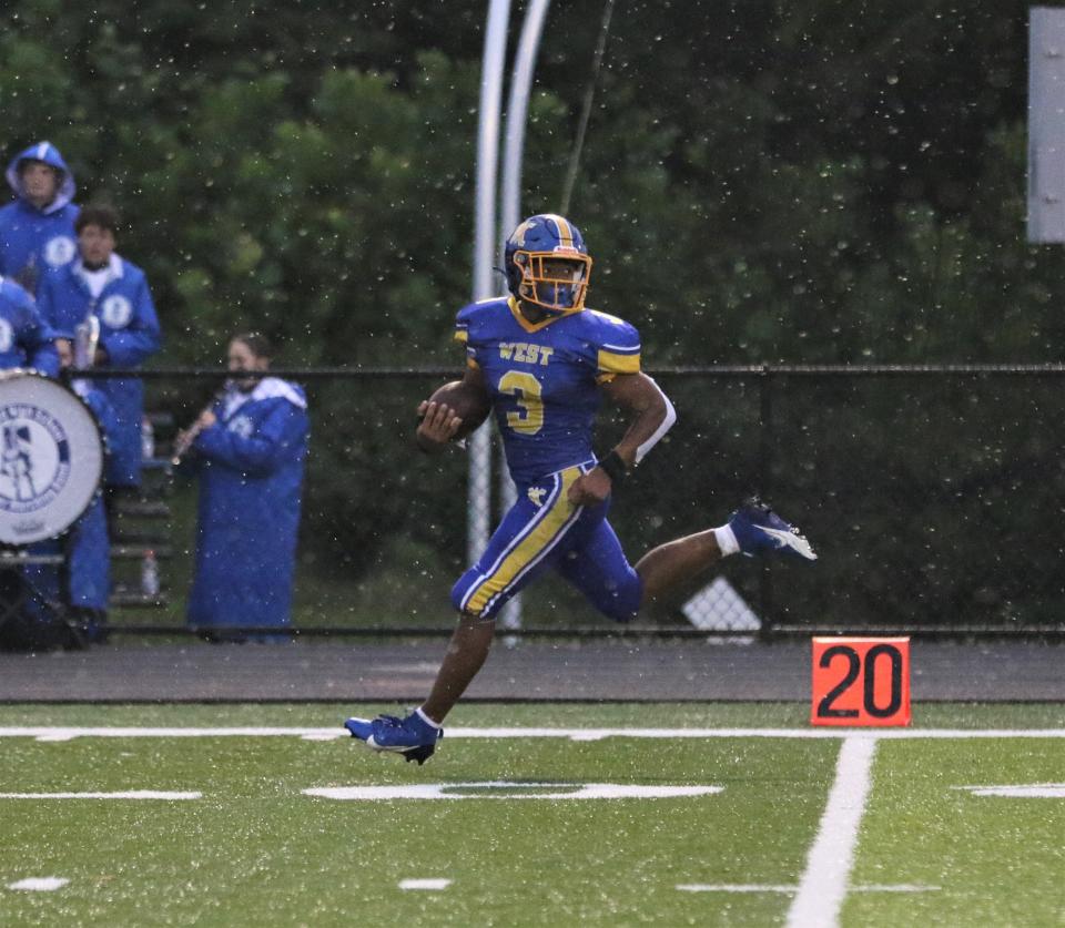 West Muskingum's Rashid Sesay looks back after out-running the Lakewood defense for a touchdown on Thursday.