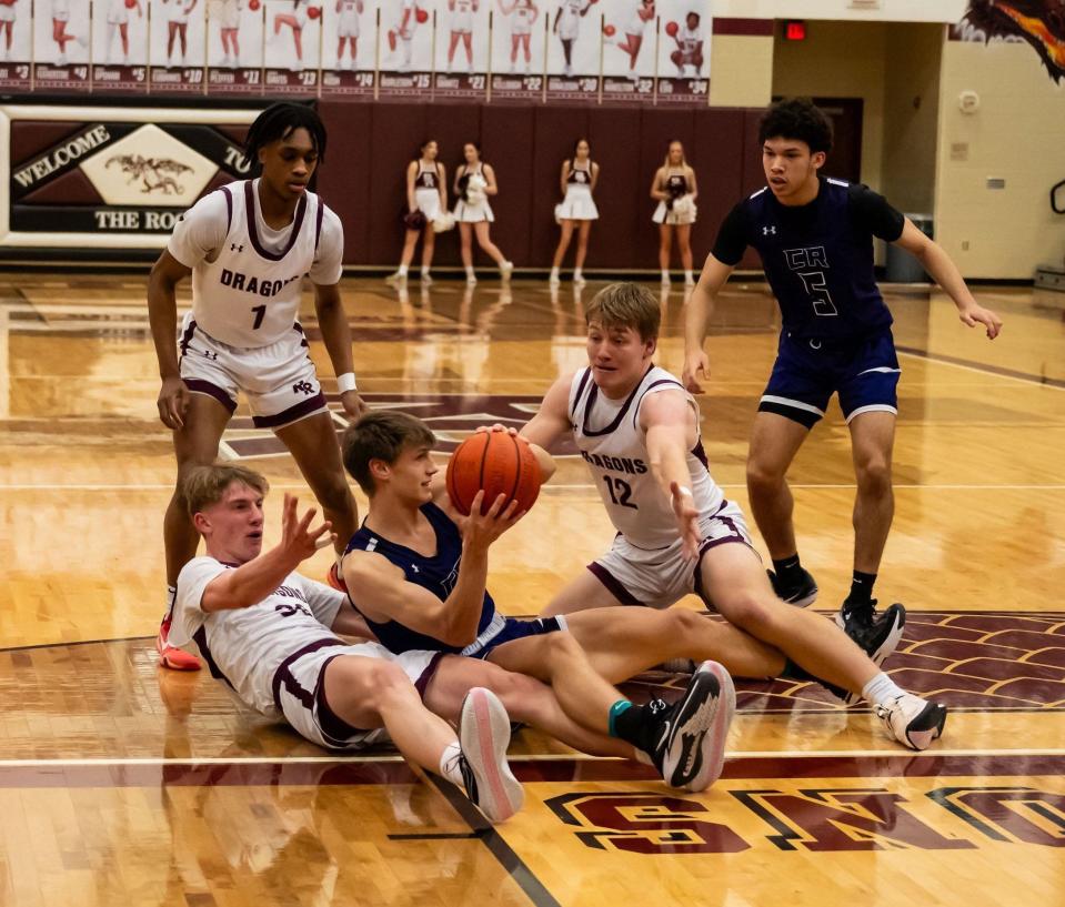 Jonathan Wenthe and Mason Cochran of Round Rock and Sam Fielding of Cedar Ridge battle for a loose ball.