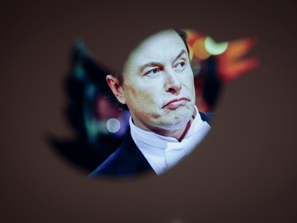 Elon Musk and a Twitter logo are seen in this illustration photo in Warsaw, Poland on 30 November, 2022. The revamped Blue Twitter subscription might not be available as in-app purchase on Apple devices when it eventually relaunches. The decision presumably was made so that Twitter can dodge Apples 30 percent cut of App Store purchases. While Elon Musk is publicly tweeting his displeasure with Apple, it appears he wants to avoid having to pay Apples fees. (Photo by STR/NurPhoto via Getty Images)