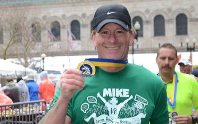 Mike Rossi holds his medal from the Boston Marathon. Source: Facebook.