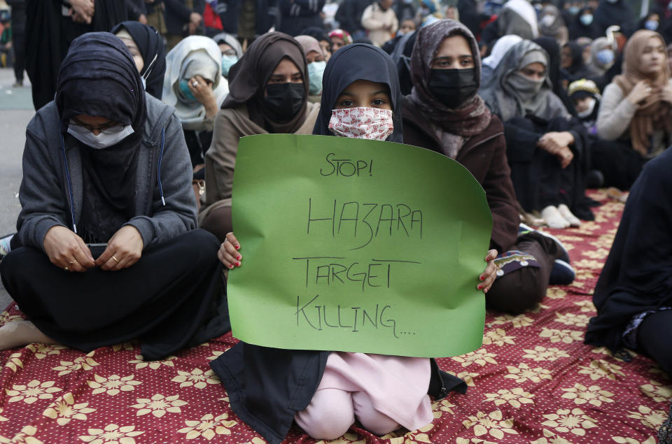 Shiite Muslims hold sit-in to protest against the killing of coal mine workers by gunmen near the Machh coal field, in Lahore, Pakistan, Friday, Jan. 8, 2021. Pakistan's prime minister Friday appealed the protesting minority Shiites not to link the burial of 11 coal miners from Hazara community who were killed by the Islamic State group to his visit to the mourners, saying such a demand amounted to blackmailing the country's premier. (AP Photo/K.M. Chaudary)