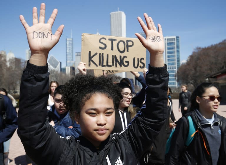 A student holds up her hands with the words "Don't Shoot" written on them during a protest against school violence in Chicago