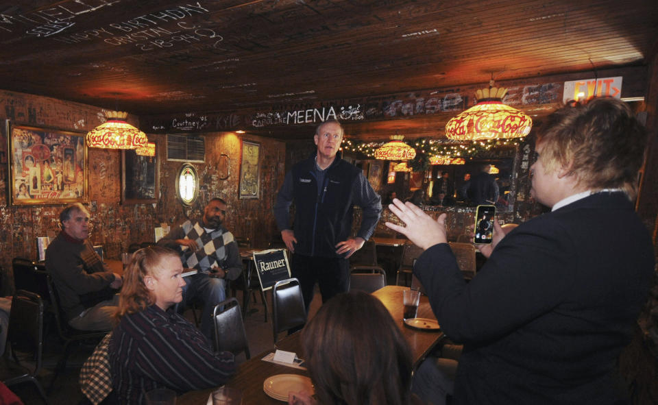 FILE - In this Jan. 7, 2014 file photo, venture capitalist Bruce Rauner, a candidate for the Republican nomination for Illinois governor, listens to comments from guests during a campaign stop at a restaurant in Carbondale, Ill. When Rauner announced plans last year to run for governor of Illinois, it was clear this wouldn’t be the kind of race the state was accustomed to. Rauner, who made $53 million in 2012 but portrays himself as an everyman in a Carhartt jacket who loves hunting and fishing, is attempting to join the list of Republican business executives who have won office in recent years with no previous elective experience. He is considered the heavy favorite in the four-way GOP primary. (AP Photo/The Southern, Steve Matzker, File)
