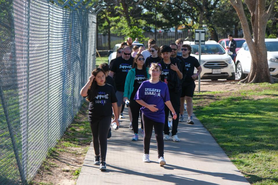 Walkers approach the Amarillo Zoo entrance at the Annual Epilepsy Foundation Walk Saturday held at Thompson Park in Amarillo.