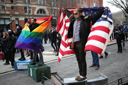 Men hold flags during a protest against U.S. President Donald Trump on the sidelines of the inauguration in Washington, D.C. January 20, 2017. REUTERS/Adrees Latifdddd