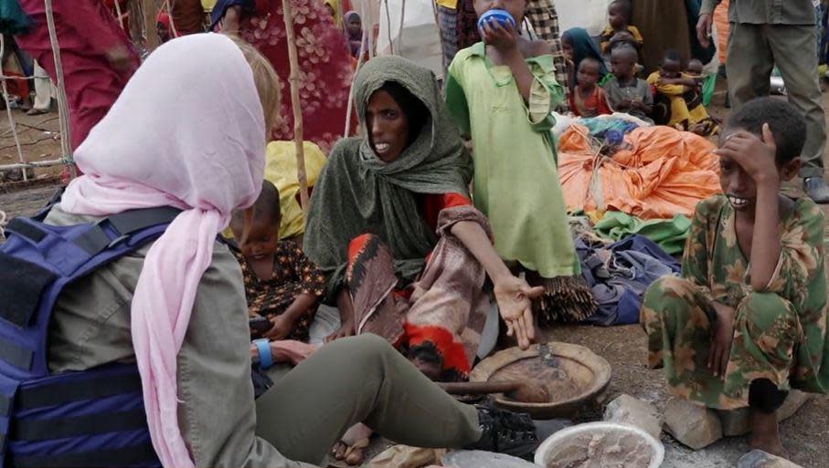 CBS News' Debora Patta, left, speaks with Bilisey Ali and her daughters not long after they travelled more than 70 miles to reach a camp for internally displaced people in Baidoa, Somalia. / Credit: CBS News