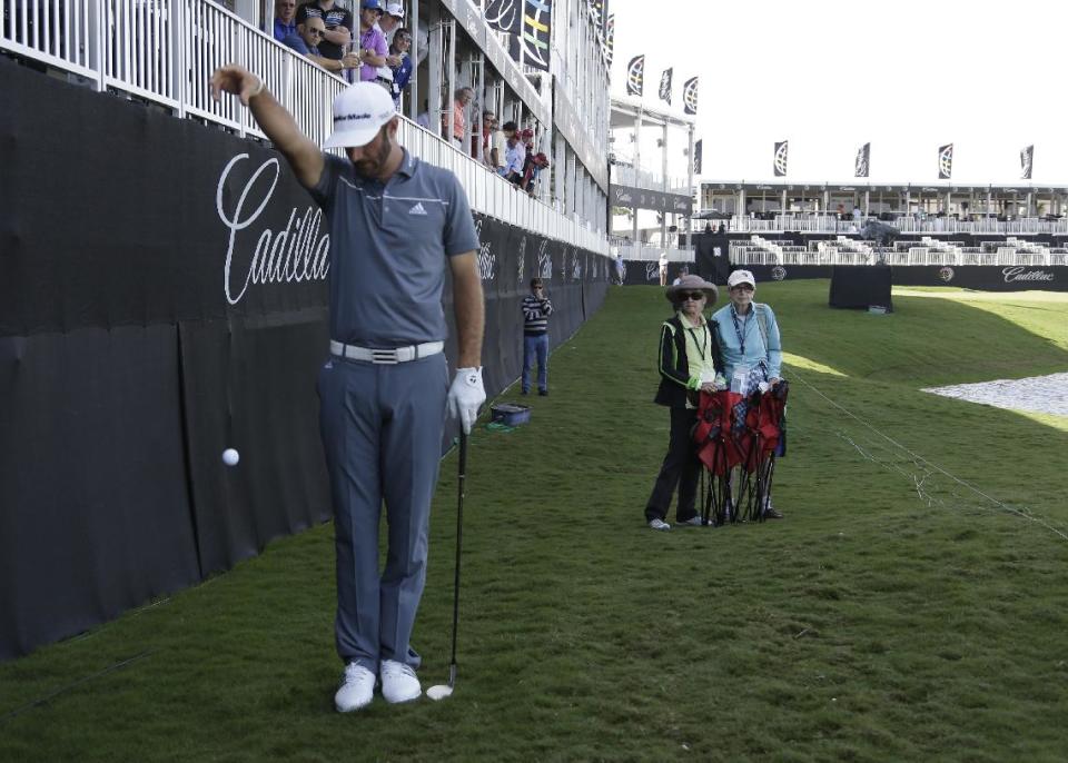 Dustin Johnson takes a drop on the ninth hole rough during the first round of the Cadillac Championship golf tournament Friday, March 7, 2014, in Doral, Fla. A severe thunderstorm delayed first round play on Thursday. (AP Photo/Lynne Sladky)